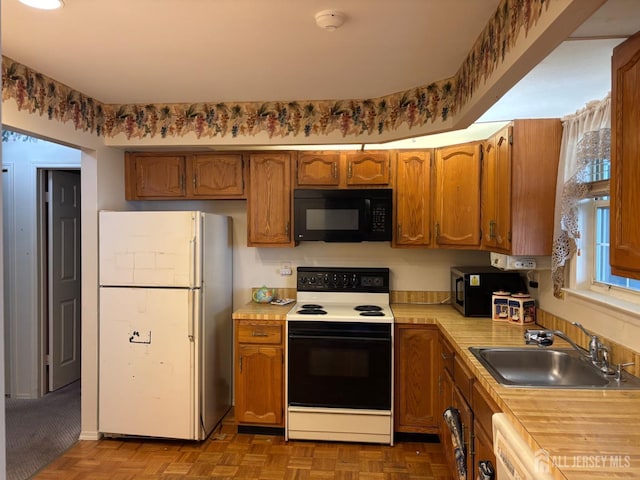 8 Benjamin Franklin Dr Unit 8E, Monroe, NJ 08831 - kitchen featuring black microwave, a sink, electric range oven, light countertops, and freestanding refrigerator