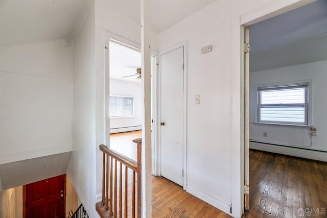 51 Delafield St, New Brunswick, NJ 08901 - hall with baseboard heating, wood-type flooring, and an upstairs landing