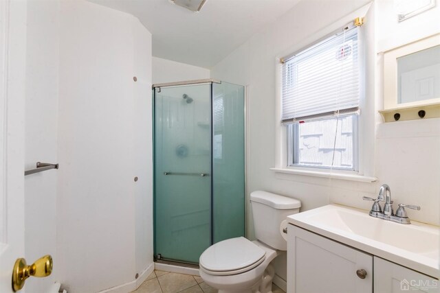 bathroom featuring a healthy amount of sunlight, an enclosed shower, and toilet