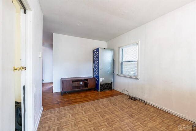 unfurnished bedroom featuring parquet floors