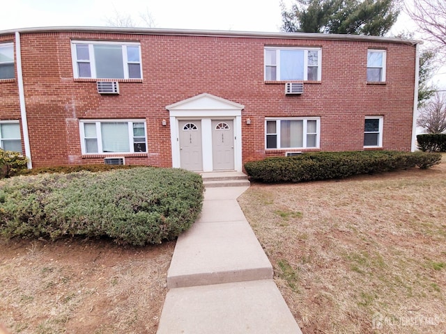 view of front of house featuring brick siding and a front lawn