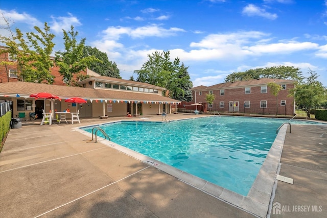 pool featuring a patio and fence