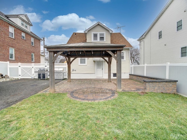 back of house featuring a gazebo, a yard, and a patio