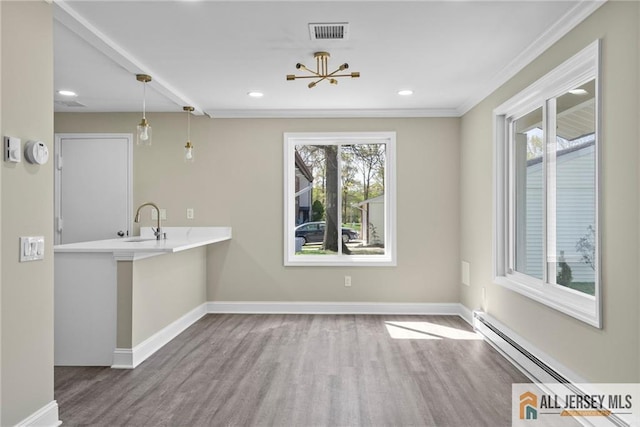 265 Crosse Dr Unit 265A, Monroe, NJ 08831 - unfurnished dining area featuring a sink, wood finished floors, baseboards, a baseboard heating unit, and recessed lighting