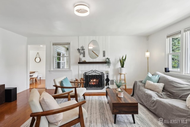 54 Morningside Rd, Colonia, NJ 07067 - living room featuring wood finished floors, healthy amount of natural light, and a lit fireplace