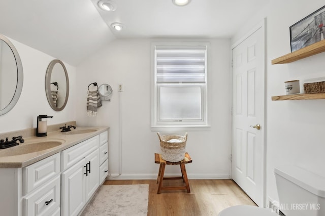 54 Morningside Rd, Colonia, NJ 07067 - bathroom with wood finished floors, double vanity, lofted ceiling, and toilet