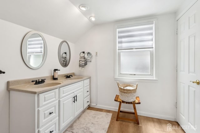 54 Morningside Rd, Colonia, NJ 07067 - bathroom featuring double vanity, wood finished floors, lofted ceiling, and plenty of natural light