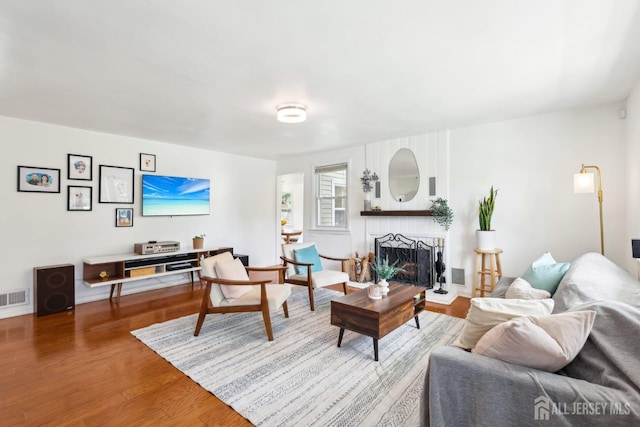 54 Morningside Rd, Colonia, NJ 07067 - living area featuring a fireplace, wood finished floors, and baseboards
