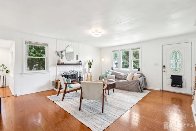54 Morningside Rd, Colonia, NJ 07067 - living room with healthy amount of natural light, a fireplace, wood-type flooring, and baseboards