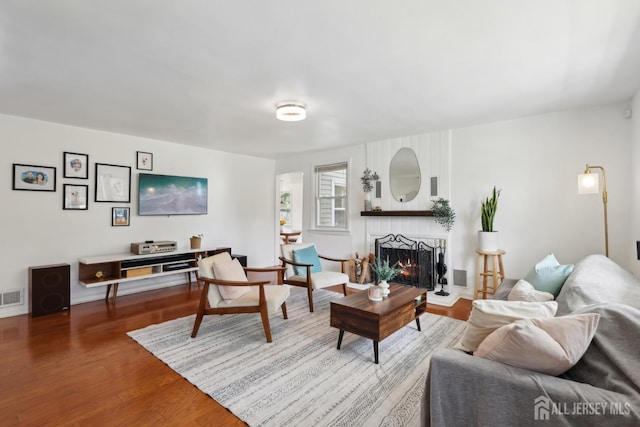 54 Morningside Rd, Colonia, NJ 07067 - living area with a fireplace, wood finished floors, and baseboards