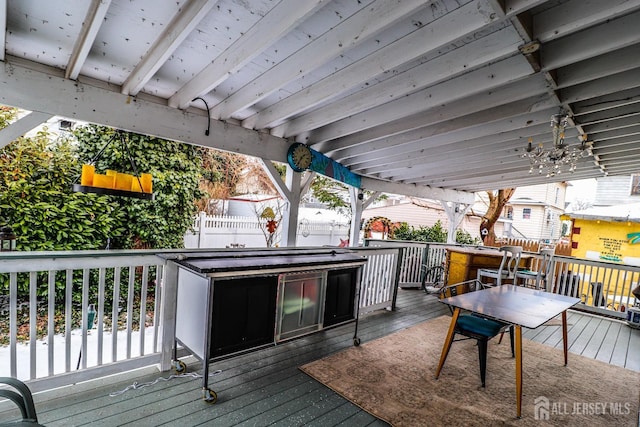 wooden terrace with a jacuzzi and fence