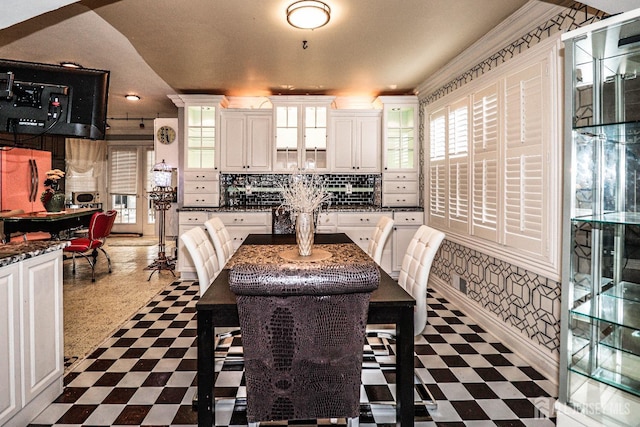 dining room with a wealth of natural light and dark floors