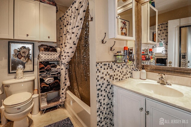 full bathroom featuring tile patterned floors, toilet, shower / tub combo, tile walls, and vanity