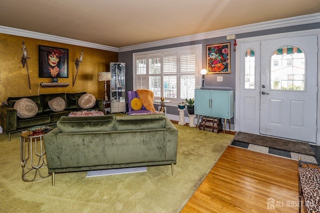 living area featuring wood finished floors and ornamental molding