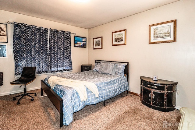 carpeted bedroom featuring baseboards