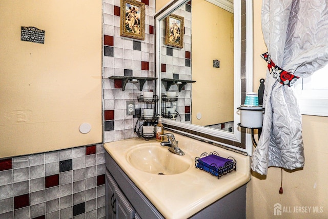 bathroom with vanity and tile walls