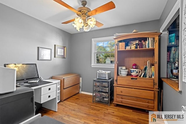 office with light hardwood / wood-style floors and ceiling fan