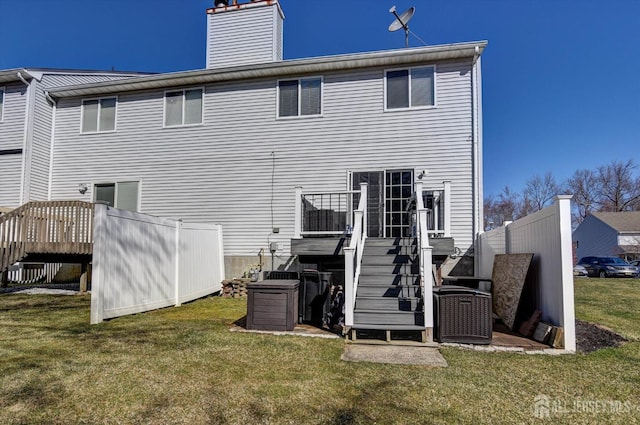 40 Forest Garden Dr, Old Bridge, NJ 07747 - back of property with a yard, a wooden deck, a chimney, and stairs