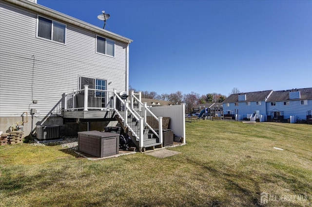 40 Forest Garden Dr, Old Bridge, NJ 07747 - back of property with stairs, a yard, and central AC unit
