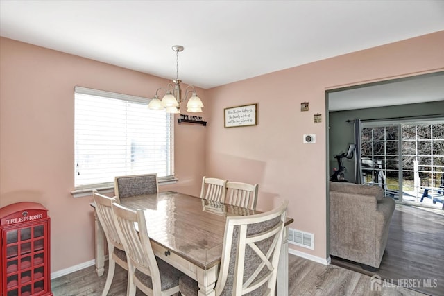 40 Forest Garden Dr, Old Bridge, NJ 07747 - dining space featuring a chandelier, wood finished floors, and plenty of natural light