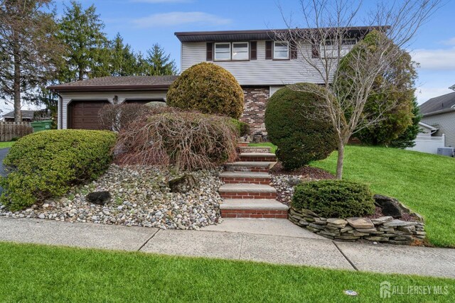 view of front property with a front yard and a garage