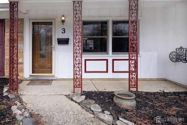 view of exterior entry with a porch