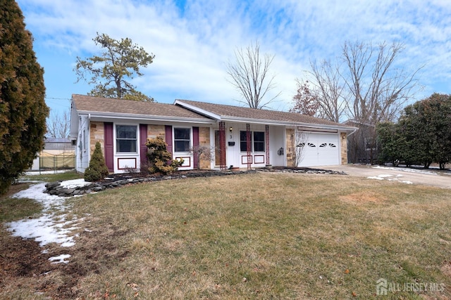 ranch-style home featuring an attached garage, driveway, and a front yard