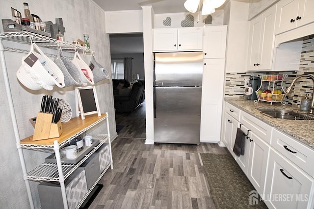 54 Highview Dr, Woodbridge Proper, NJ 07095 - kitchen with freestanding refrigerator, wood finished floors, backsplash, white cabinetry, and light stone countertops