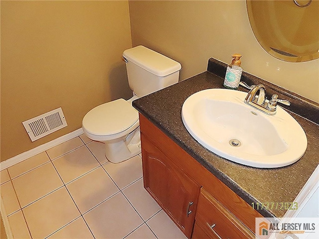 bathroom featuring tile patterned flooring, vanity, and toilet