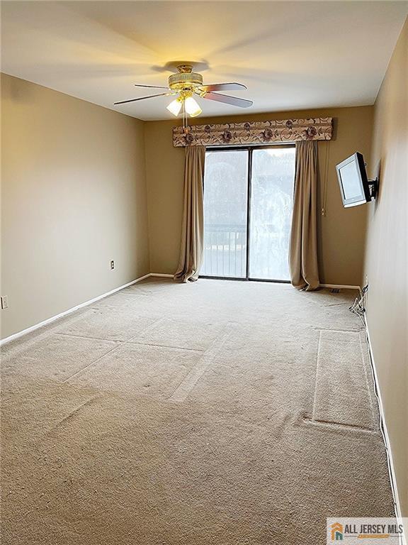 carpeted empty room with ceiling fan