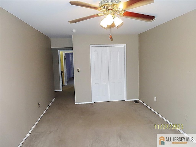 unfurnished bedroom featuring ceiling fan, carpet floors, and a closet