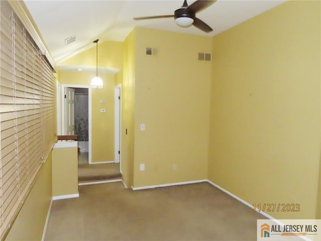 spare room with carpet flooring, ceiling fan, and lofted ceiling