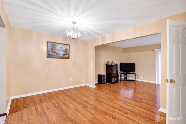 interior space featuring visible vents, baseboards, and wood finished floors