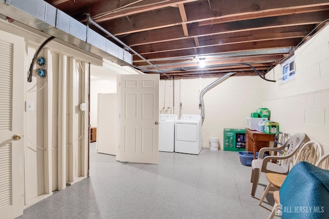 unfinished below grade area with independent washer and dryer and tile patterned floors