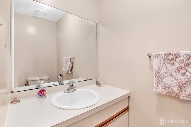 bathroom featuring vanity and toilet