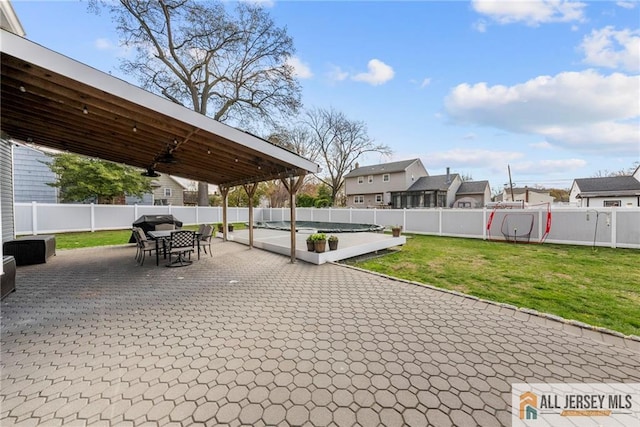 view of patio featuring outdoor dining space, a residential view, and a fenced backyard