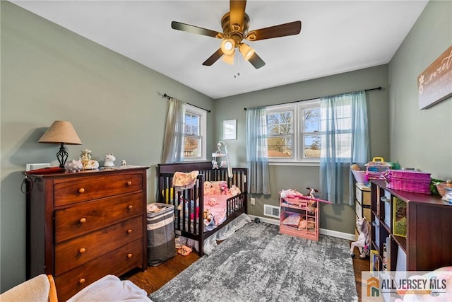 bedroom featuring baseboards, ceiling fan, and visible vents
