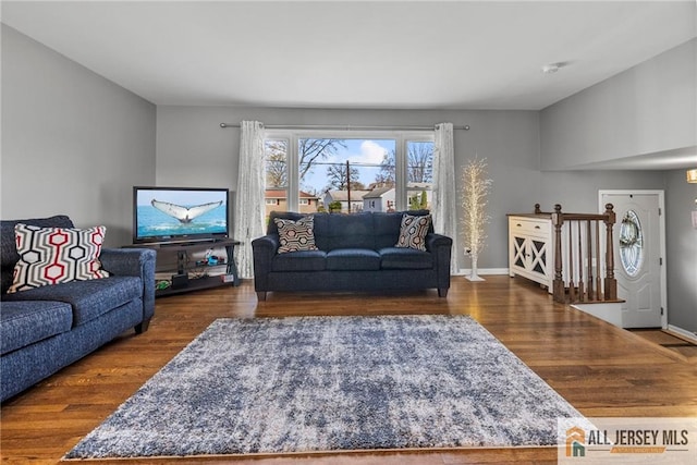 living room featuring baseboards and wood finished floors