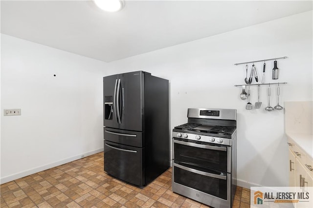 235 Brook Ave, North Plainfield, NJ 07060 - kitchen with refrigerator with ice dispenser, double oven range, light countertops, and brick patterned floors