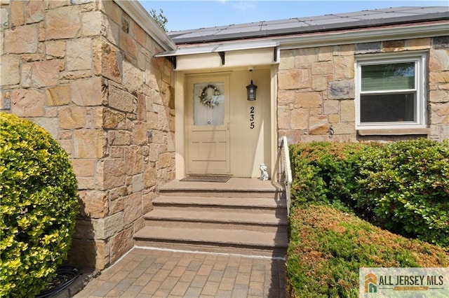235 Brook Ave, North Plainfield, NJ 07060 - property entrance featuring stone siding and roof mounted solar panels
