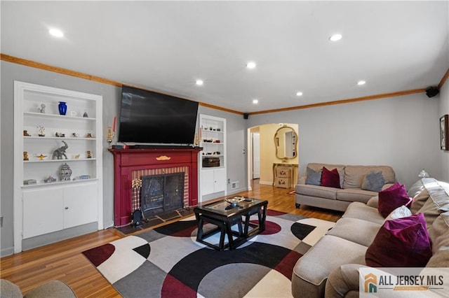 235 Brook Ave, North Plainfield, NJ 07060 - living area featuring arched walkways, crown molding, built in shelves, a fireplace, and wood finished floors