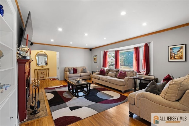 235 Brook Ave, North Plainfield, NJ 07060 - living area featuring crown molding, wood finished floors, arched walkways, and recessed lighting