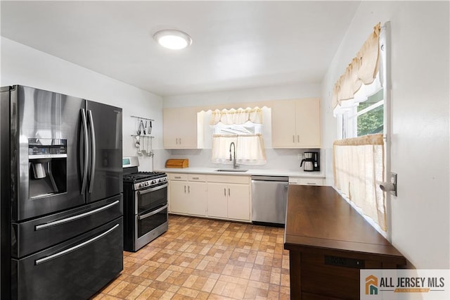 235 Brook Ave, North Plainfield, NJ 07060 - kitchen featuring appliances with stainless steel finishes, light countertops, and white cabinets