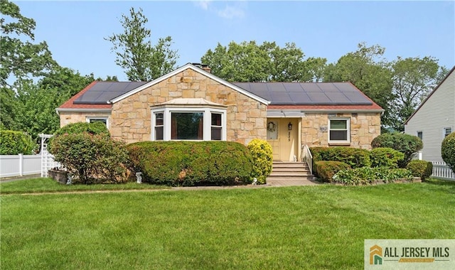 235 Brook Ave, North Plainfield, NJ 07060 - view of front of property featuring stone siding and roof mounted solar panels