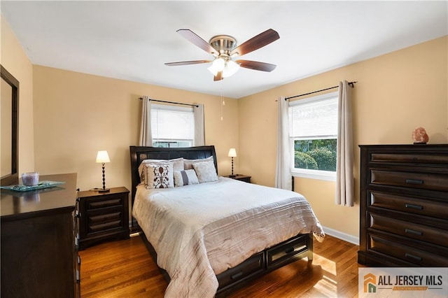 235 Brook Ave, North Plainfield, NJ 07060 - bedroom featuring multiple windows, dark wood-style flooring, and a ceiling fan