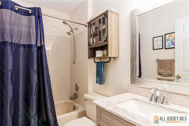 full bathroom featuring shower / tub combo with curtain, toilet, and vanity