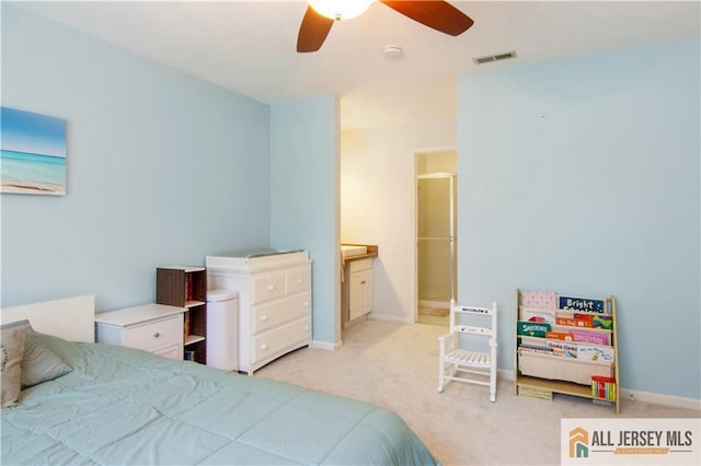 carpeted bedroom with visible vents, baseboards, ceiling fan, and connected bathroom