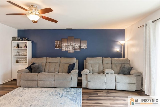 living room with a ceiling fan, wood finished floors, and visible vents