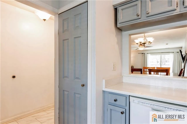 bar featuring white dishwasher, baseboards, and a chandelier