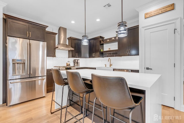 40 Cambridge Rd, Edison, NJ 08817 - kitchen with high end refrigerator, wall chimney range hood, a kitchen island, light countertops, and open shelves